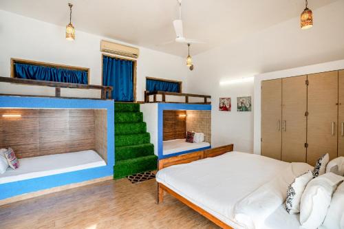 a dorm room with two beds and a staircase at CASA DIOS Luxury Villas in Khandala