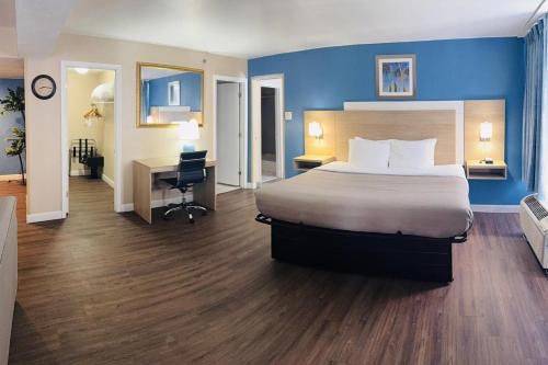 a hotel room with a bed and a desk at Quality Inn & Suites Conference Center in New Port Richey