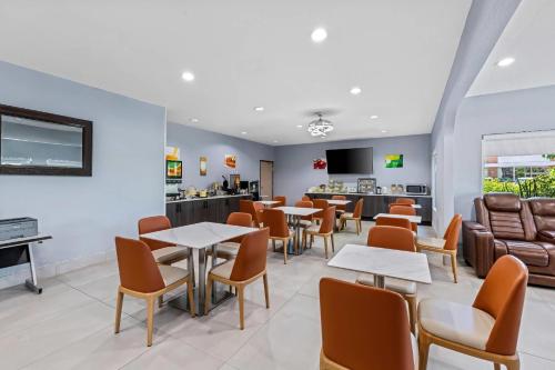 a waiting room with tables and chairs and a counter at Quality Inn & Suites Manhattan in Manhattan