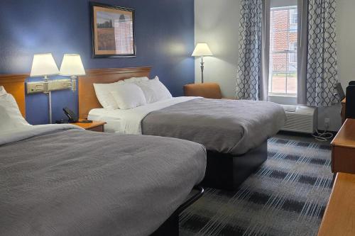 a hotel room with two beds and two lamps at Quality Inn Dublin I-81 in Dublin