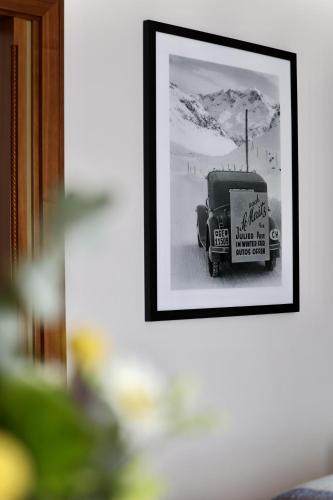 a black and white photo of an old car in a picture at Grand Hotel des Bains Kempinski in St. Moritz