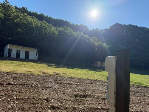 a refrigerator in a field with the sun shining at Camping-Baven-Toven Naturae in (( Bulshizë ))