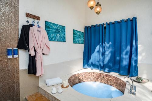 a bathroom with a sink and a blue shower curtain at CASA DIOS Luxury Villas in Khandala