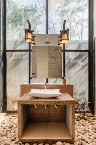 a bathroom with a sink and a large window at CASA DIOS Luxury Villas in Khandala