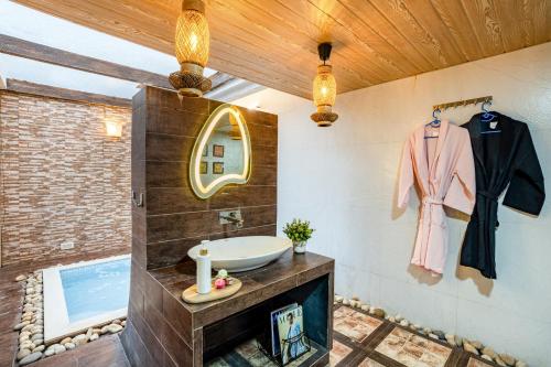 a bathroom with a sink and a mirror at CASA DIOS Luxury Villas in Khandala