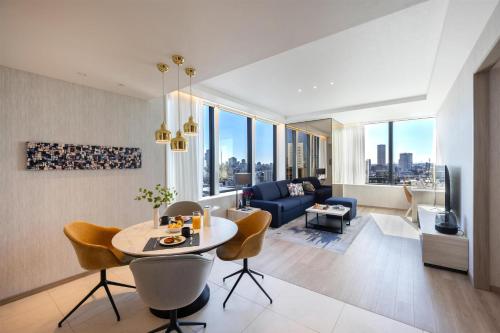 a living room with a table and chairs and a couch at Hyatt House Tokyo Shibuya in Tokyo