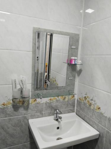 a bathroom with a sink and a mirror at Гостевой дом Hotel Allanazar Ota in Khiva
