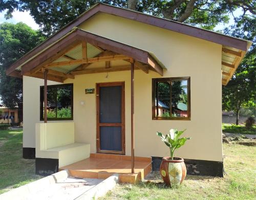 a small house with a porch at Mgulani Lodge Hotel in Dar es Salaam