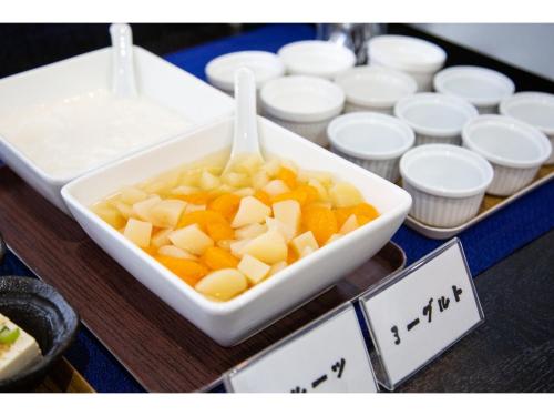 a bowl of fruit sitting on top of a table at Smile Hotel Kumamoto Suizenji - Vacation STAY 73089v in Kumamoto