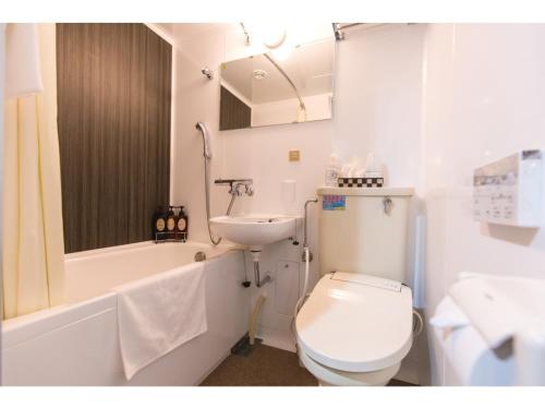 a bathroom with a white toilet and a sink at Smile Hotel Kumamoto Suizenji - Vacation STAY 73093v in Kumamoto