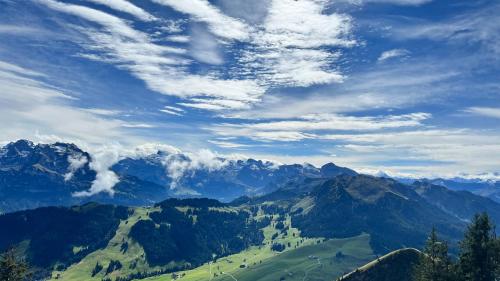 a view of a mountain valley under a cloudy sky at Modern appartment self-check-in in Stans