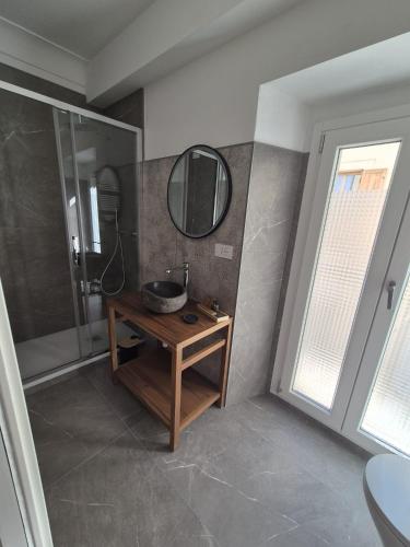 a bathroom with a sink and a mirror on the wall at Civico 41 in Pettorano sul Gizio