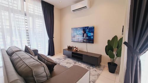 a living room with a couch and a flat screen tv at JMKT 549 Homestay Mutiara Rini 8-10 pax in Johor Bahru