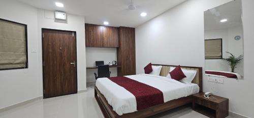 a bedroom with a bed and a desk in it at Daze Off Studio house in Bhuj