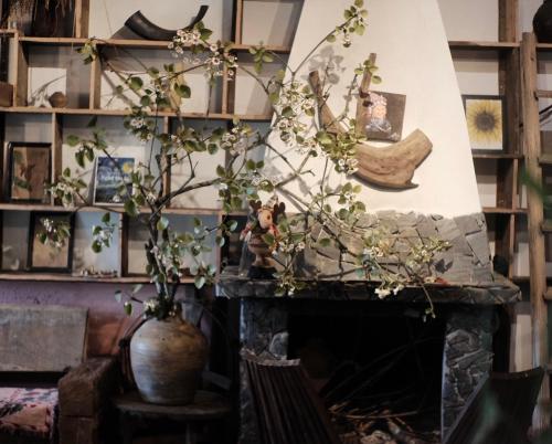 a fireplace in a living room with a plant at Pavi garden in Sa Pa