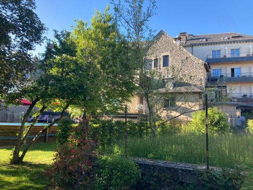 a garden in front of a building at Logis Hôtel Restaurant Gilles Moreau Laguiole in Laguiole