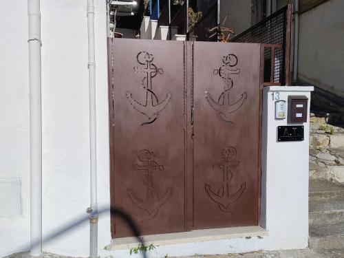 a wooden door with drawings of anchors on it at Al VICO TREDICI in Gaeta