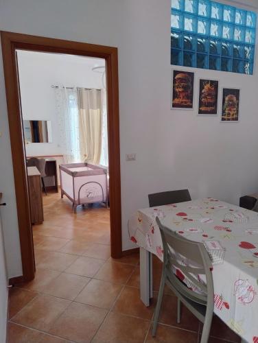 a dining room with a table and a room with a chair at Al VICO TREDICI in Gaeta