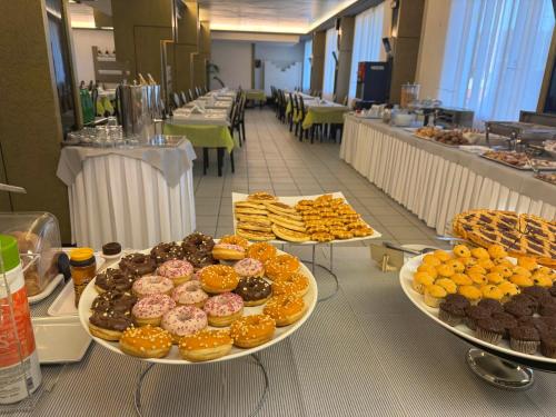 a buffet of donuts and other pastries in a cafeteria at Park Hotel in Castrocaro Terme