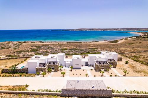 an aerial view of a white building on the beach at Cato Agro 1, Seafront Villa with Private Pool in Karpathos Town