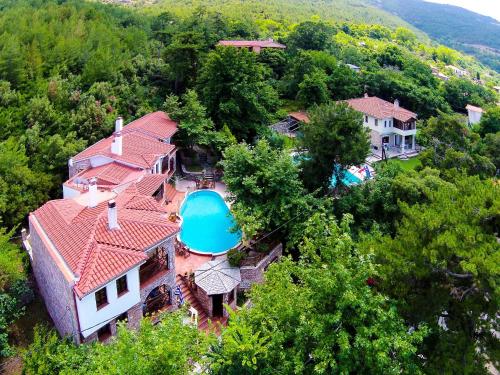 an aerial view of a house with a swimming pool at Kazaviti Luxury Suites in Mikrós Prínos