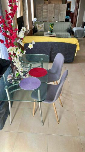 a living room with a glass table and chairs at Alpha Apartment View in Serres