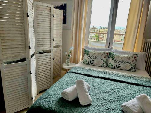a bedroom with a bed with towels on it at Alpha Apartment View in Serres