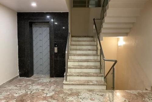 a staircase leading to a door in a building at Hotel Amansara in Lucknow