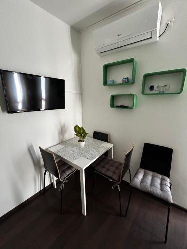 a dining room with a white table and chairs at Lexi Classic 2 in Hajdúszoboszló
