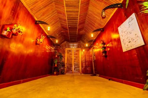 a hallway with red walls and a clock on the wall at Cinnamon Airport Residencies in Katunayaka