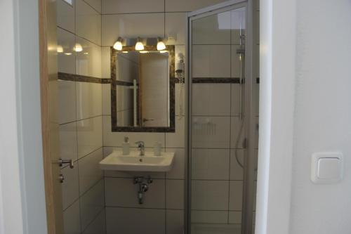 a bathroom with a sink and a mirror at Ferienwohnungen Schöbringer in Weyregg