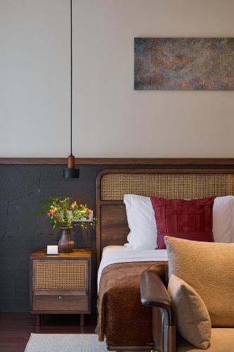 a bedroom with a bed and a table with a chair at ARULA J Hotel in Lijiang