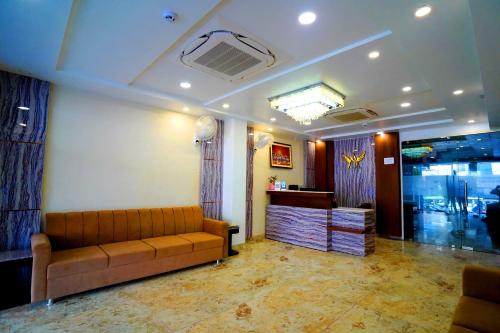 a living room with a couch and a counter at Hotel Amansara in Lucknow