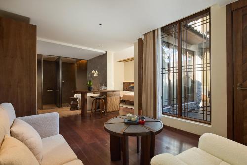 a living room with a couch and a table at ARULA J Hotel in Lijiang