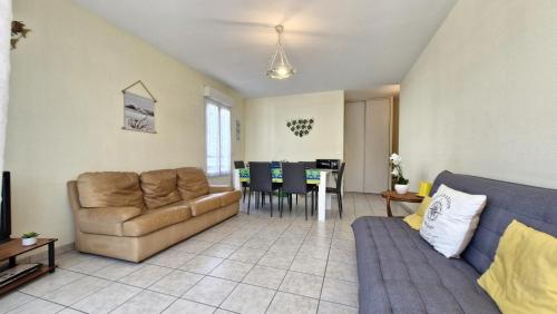 un salon avec un canapé et une table dans l'établissement Royan - APPARTEMENT avec EMPLACEMENT IDEAL - terrasse - garage privatif, à Royan