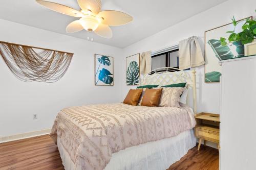 a bedroom with a bed and a ceiling fan at Luxury Oceanfront Condo with Pools, Hot Tub, Gym & Grill by myBeach Vacation Rentals in Myrtle Beach