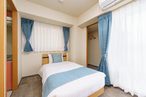 USP HOTEL Kitahorieにあるベッド
