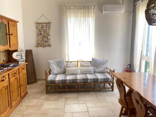 a living room with a couch and a table at My Charming Flat - Sea Front View in Rivabella