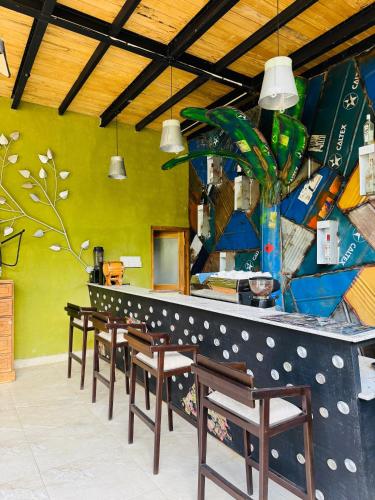 a bar with a row of tables and chairs at The Feel Luxury Boutique Hotel Ella in Ella