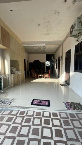 a living room with a rug on the floor at Homestay Yaa Syafi in Bireun