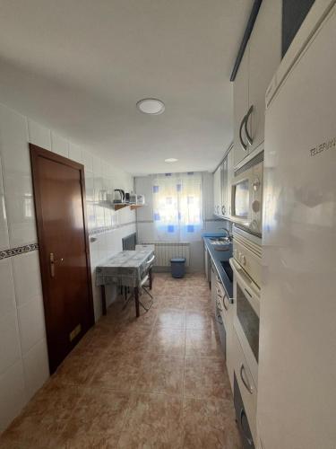 a kitchen with a sink and a table in it at Pirineo Aragonés. Casa La Paz in Sabiñánigo