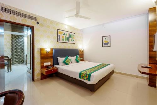 a bedroom with a large bed in a room at Treebo Seasons - Heritage Town Pondicherry in Puducherry