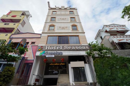 a building with a hotel seasons sign in front of it at Treebo Seasons - Heritage Town Pondicherry in Puducherry