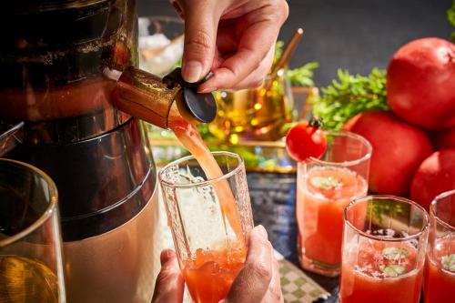 a person is pouring a drink into a glass at Rantei in Sendai