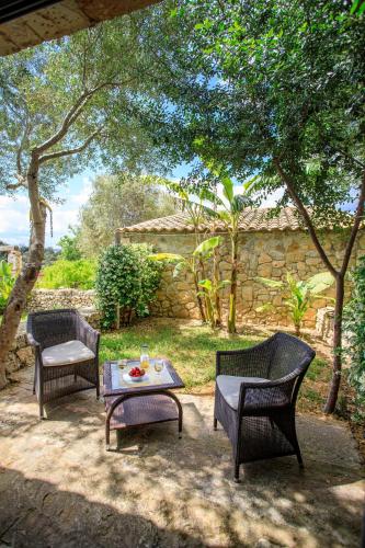 two chairs and a coffee table on a patio at Agroturisme Es Racó De Maria in Maria de la Salut