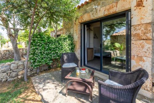 a patio with two chairs and a table at Agroturisme Es Racó De Maria in Maria de la Salut