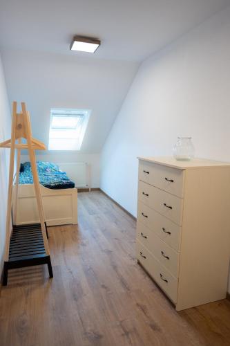 a bedroom with a bunk bed and a dresser at Apartmány Močovice in Močovice