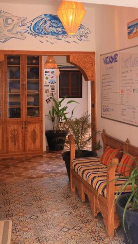 a living room with a couch in a room at Surf hostel Morocco in Tamraght Ouzdar