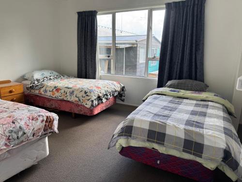 Postel nebo postele na pokoji v ubytování Mount Maunganui House