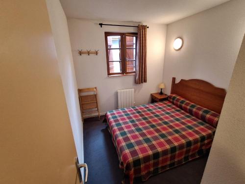 a small bedroom with a bed and a window at Les Estives de Cauterêts in Cauterets